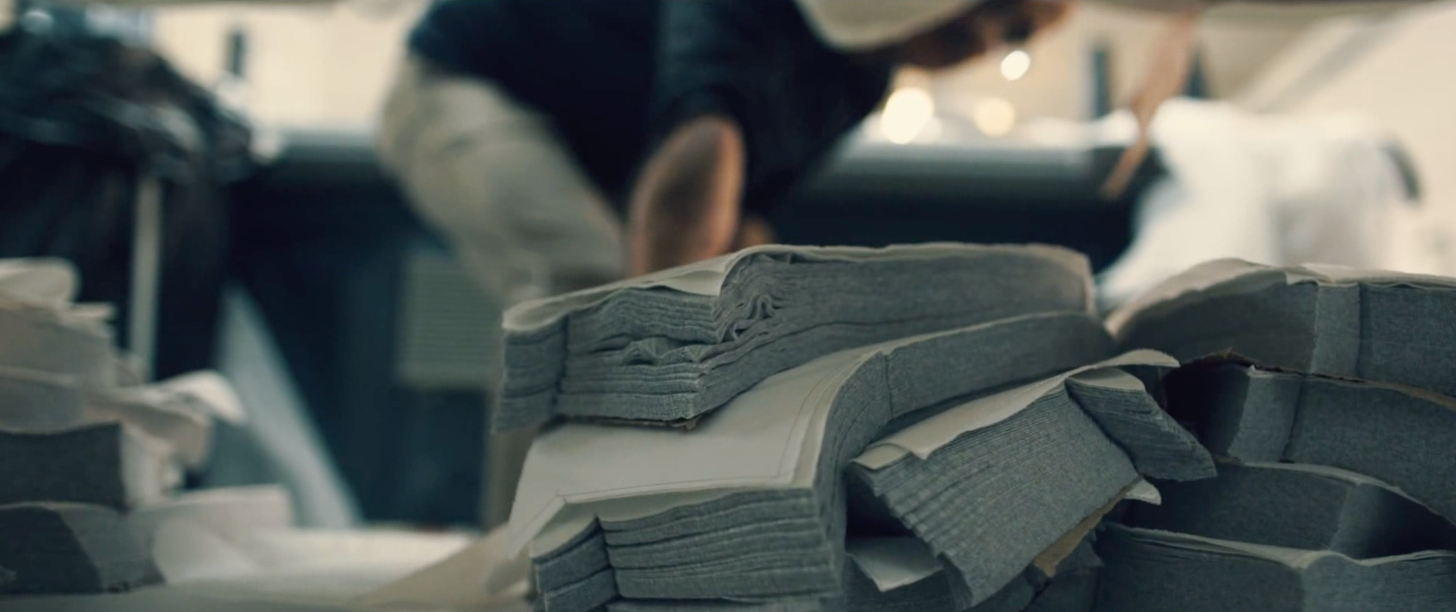 Organic cotton jerseys laid out on a cutting shelf in daylight