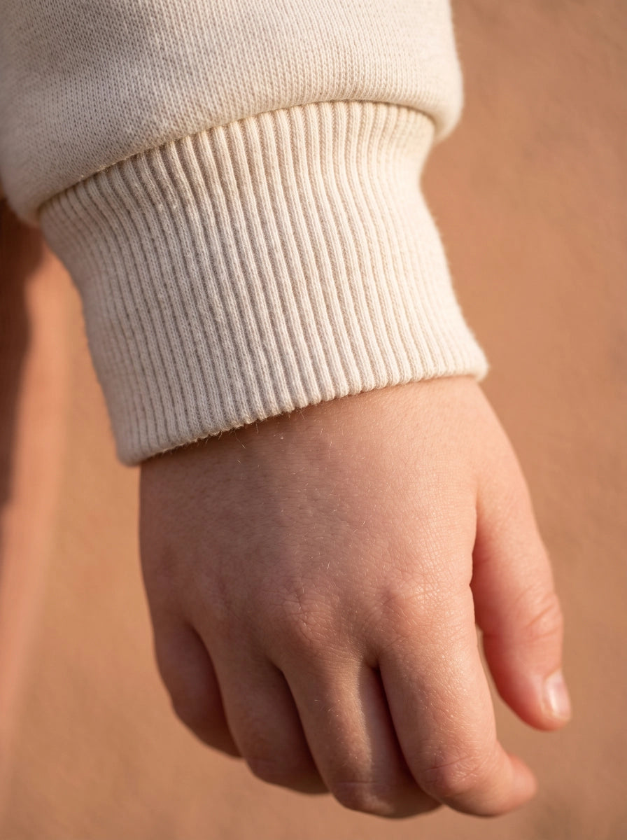 Close-up of ribbed cuff on a finished garment, showing stretch.