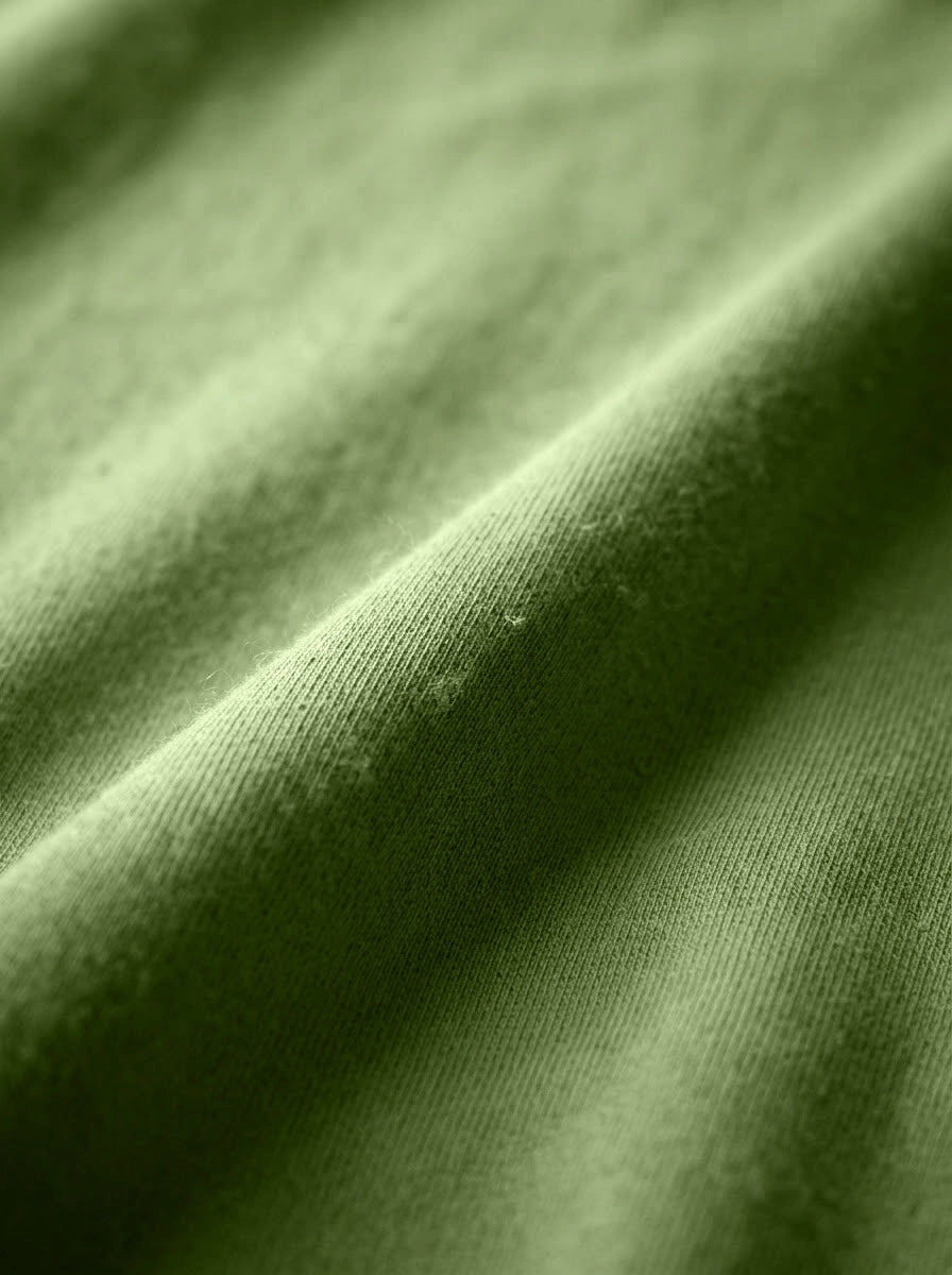 Organic cotton single jersey — the base fabric of the collection.